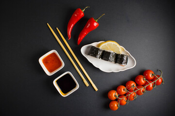 A set of sushi rolls is served on a dark background. Japanese menu. Delicious traditional japanese...