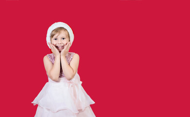 Cute adorable smiling girl waiting for presents isolated on red