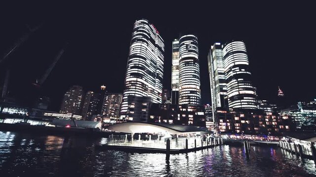 Night view of Barangaroo Skyscrapers from a moving boat, Sydney. Slow motion
