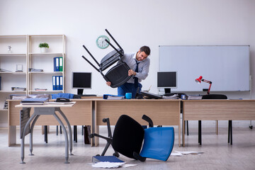 Young male employee unhappy with excessive work