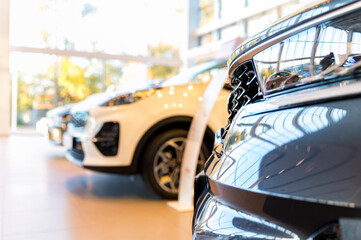 New shiny cars at dealer showroom blurred background
