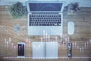 Multi exposure of financial chart drawing over table background with computer. Concept of research....