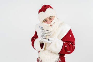 Santa Claus holds a cart on his hand. Isolated on white