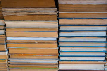 Background of all stacked books and sun light