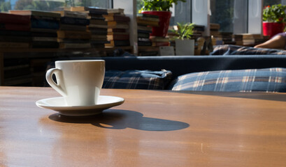 Breakfast table near to the window with a cup of coffee
