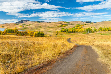 Fototapeta premium Country winding road going into the distance to the hills