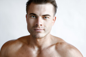 Muscular sexy model sports young man on white background. Portrait of beautiful smiling healthy guy.