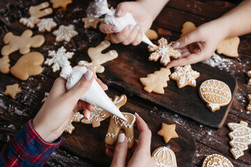 Friends decorating Christmas gingerbread cookies