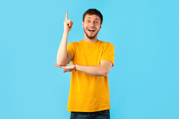 Excited man having great idea and pointing up