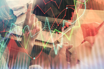 Double exposure of man and woman working together and forex chart hologram. Business concept....