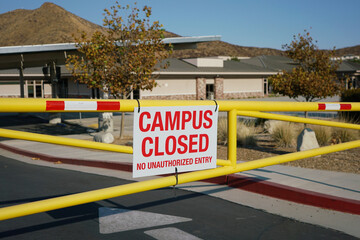 Close up of school campus closed sign on gate