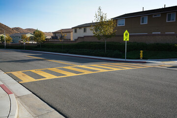 Low angle view of crosswalk and school crosswalk sign