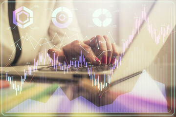 Double exposure of businesswoman hands typing on computer and financial graph hologram drawing. Stock market analysis concept.