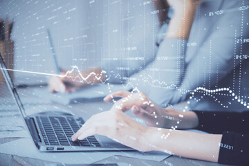 Multi exposure of woman hands typing on computer and financial chart hologram drawing. Stock market analysis concept.