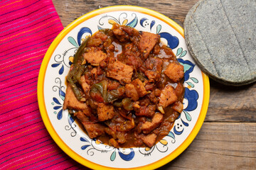 Pork chops with red sauce also called mexicana style on wooden background