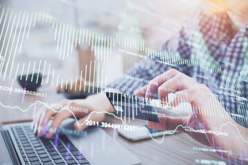 Double exposure of man hands holding a credit card and Forex graph drawing. Stock trading and digital fintech in Internet E-commerce concept.