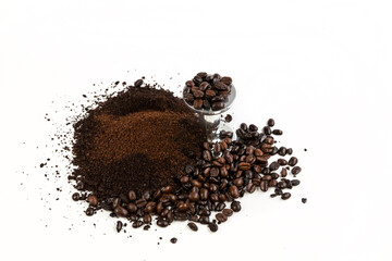 Coffee beans and grounds piled by an espresso tamper top down view