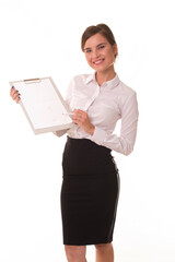 Office worker posing at camera with tablet for notes. Brunette girl shows with a pen on the empty space for the inscription and logo.