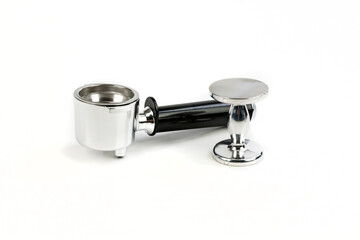 Black and silver coffee filter holder and metal tamper sitting close together