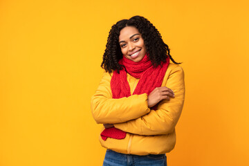 Cheerful Black Lady Wearing Winter Jacket Posing Over Yellow Background
