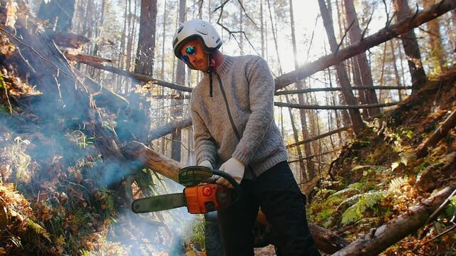 Forest Ranger holding a chainsaw in the forest