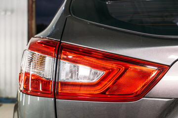 Polished optics of rear lights of car, close up.
