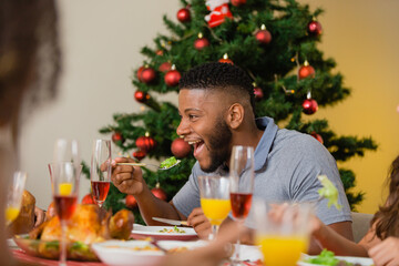 Summer Christmas dinner in Brazil. Real Brazilian family having fun at the Latin American Christmas party. latin man having dinner