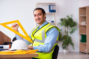 Young male architect working in the office