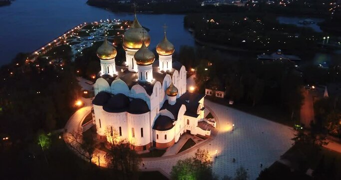 Scenic view from drone of medieval Yaroslavl Orthodox Assumption cathedral on background with Volga River and cityscape at night, Russia
