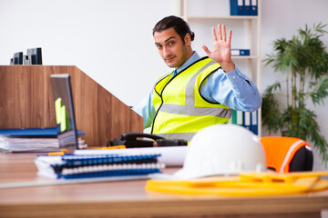 Young male architect working in the office