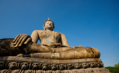 statue of buddha with blue sky background.