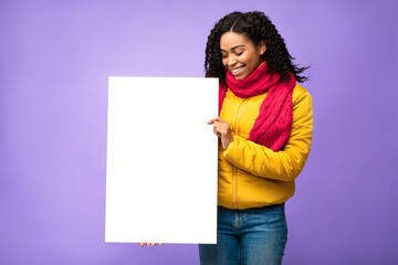 Black Lady Posing With Blank Paper Board On Purple Background