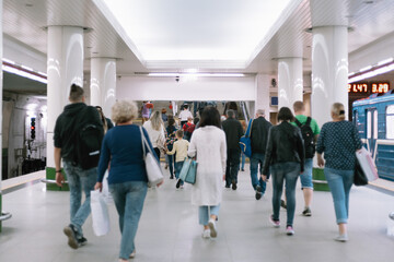 crowd of passengers at a subway station in subway.