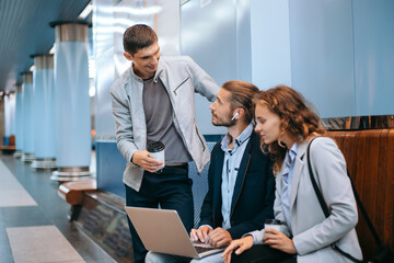 young business people discussing work issues on the subway platform .