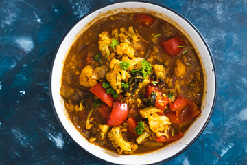 plant-based food,  vegan cauliflower and capsicum curry dish with indian spices