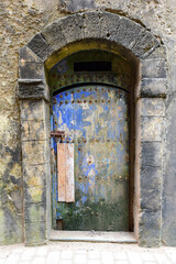 Ancient stone arched entrance with old wooden door, Essaouira, Morocco