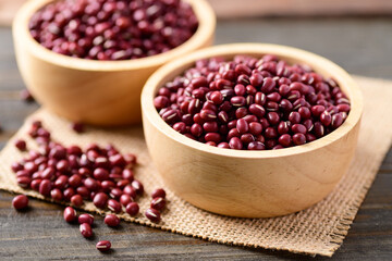 Azuki beans or red mung beans in a bowl on wooden table