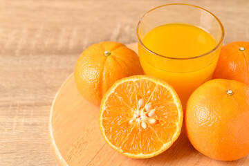 Fresh Honey Murcott orange fruit and juice on wooden background, Healthy drink