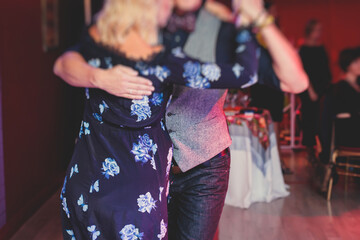 Couples dancing traditional latin argentinian dance milonga in the ballroom, tango salsa bachata...
