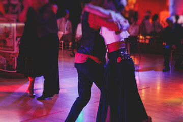 Couples dancing traditional latin argentinian dance milonga in the ballroom, tango salsa bachata...