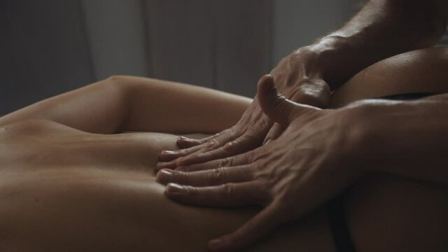 Therapist hands massaging slim girl body. Unknown woman relaxing in spa.
