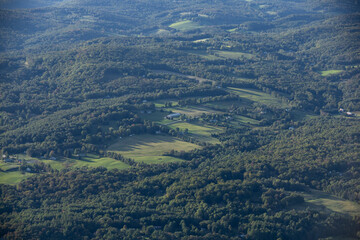 Farm fields glow in the late afternoon sun among the forests of Brownsville, Vermont