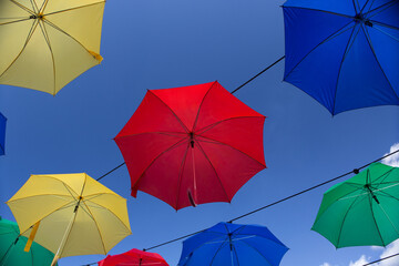 Umbrella street decoration. The blue sky of colorful umbrellas in the city. Umbrella Sky Project.