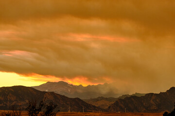 Smoke from the Cameron Peak forest fire rolling through the Rockies, obscuring the mountain range...