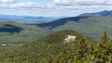 Naklejka premium The summit of North Sugarloaf stands over NH Route 302 in the White Mountains