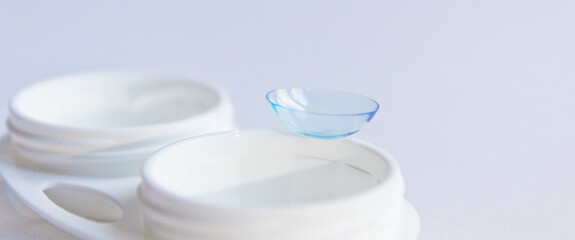 Soft contact lenses and white plastic case. Close up. Selective focus.
