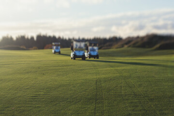 Obraz premium Golf electric cars riding on a golf course in the sunny day, golf carts drive with golfers in resort club