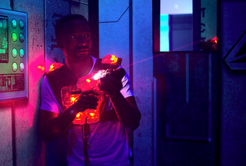 entertainment war game laser gun playing in dark with black lignt