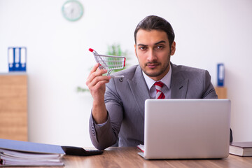 Young male employee in e-commerce concept