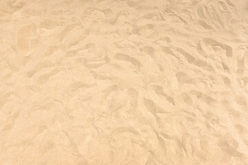 Fototapeta na wymiar background and texture of yellow sand pattern on a beach in summer
